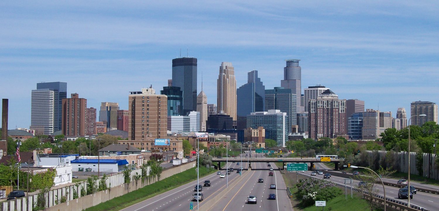 An unpacked highway stretches into the distant city and its skyline.