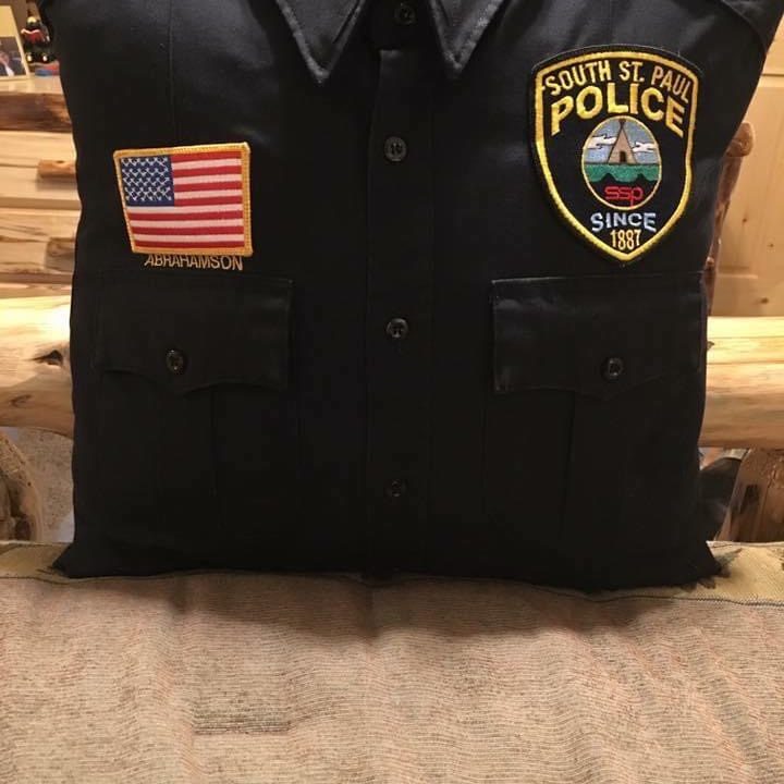 A police uniform converted into a throw pillow.
